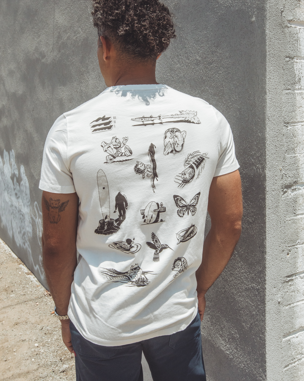 Back of vintage white men’s t-shirt featuring black hand-drawn illustrations of Imperfects’ surfboard models, celebrating the full Laminate Library lineup by Uncle Dane Danner.
Laminate Library T-Shirt in Vintage White.