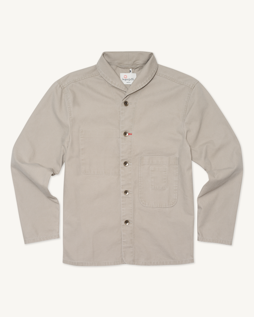 Flat lay of men’s Shepherd’s Shirt in Badlands, crafted from 10.7 oz organic cotton canvas, featuring a front chest pocket, stand collar, and brass-tone buttons.