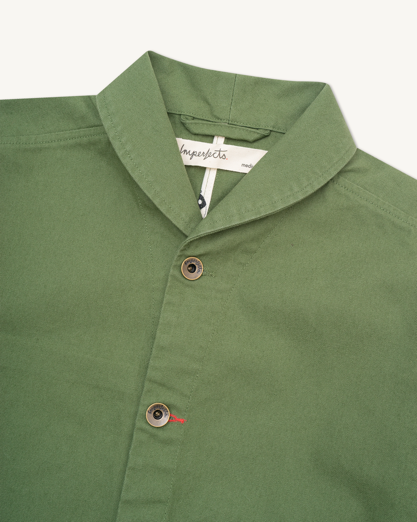 The Shepherds Shirt is a silhouette born of the joining of a family favorite vintage Kimono and a 1920’s French field shirt. This piece has a Kimono style lip collar, French split side seams, and Corozo Buttons. It is finished with a heavy stone wash for effect and comfort and has a refined crop in the sleeves so you can be sure to easily check your timepiece.

Detail

9.2oz, 100% Organic Cotton Canvas
Durable Brass Tack Buttons
Triple Pocketing - One &nbsp;Internal Drop-In Pocket, One External w/ Hidden Co