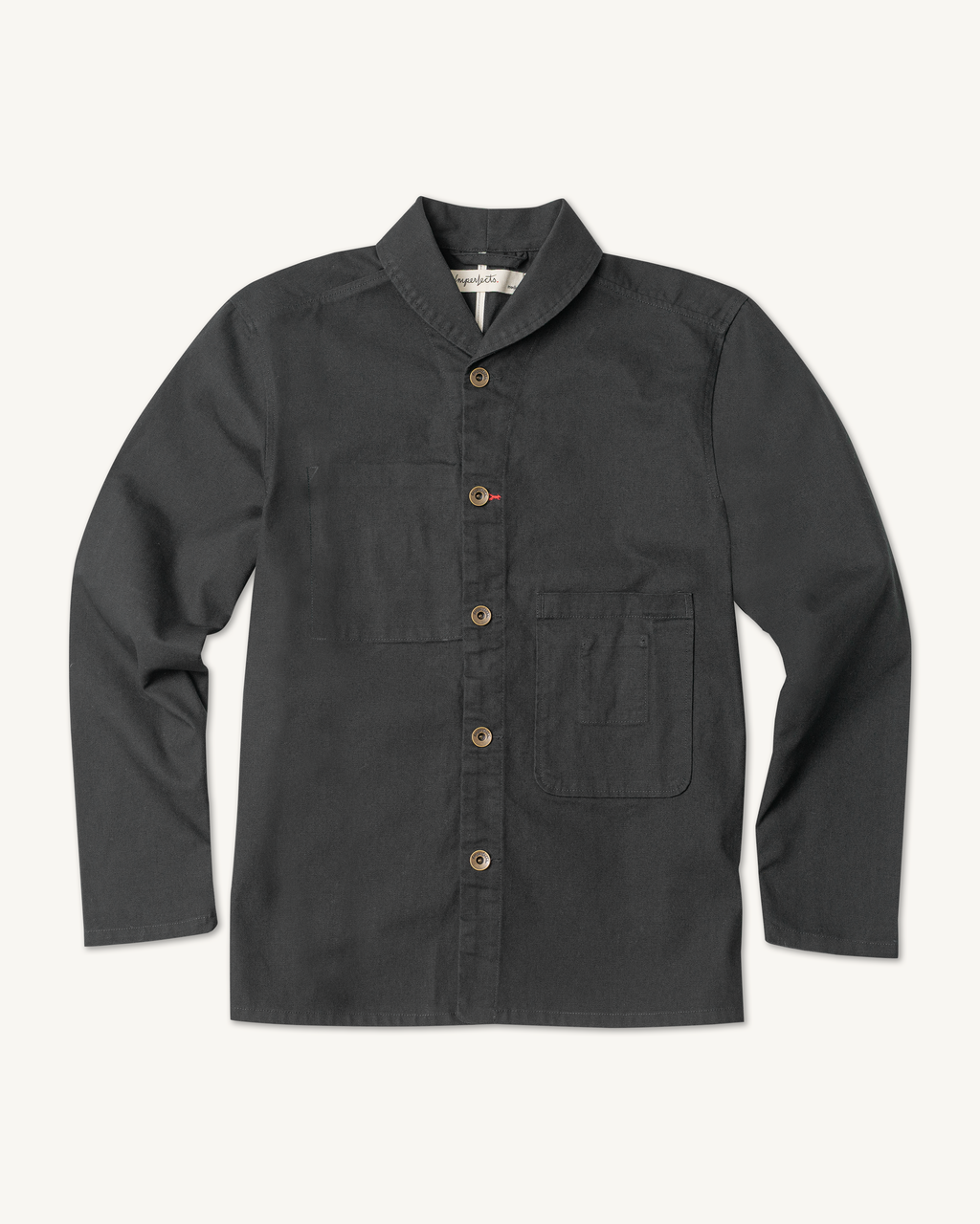 The Shepherds Shirt is a silhouette born of the joining of a family favorite vintage Kimono and a 1920’s French field shirt. This piece has a Kimono style lip collar, French split side seams, and Corozo Buttons. It is finished with a heavy stone wash for effect and comfort and has a refined crop in the sleeves so you can be sure to easily check your timepiece. Obsidian.