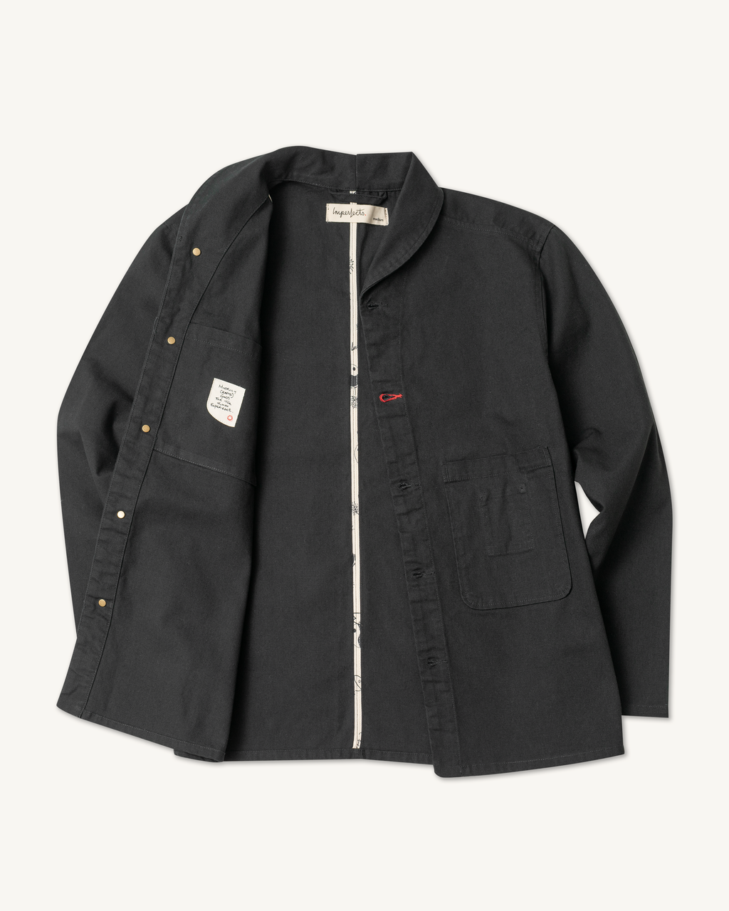 The Shepherds Shirt is a silhouette born of the joining of a family favorite vintage Kimono and a 1920’s French field shirt. This piece has a Kimono style lip collar, French split side seams, and Corozo Buttons. It is finished with a heavy stone wash for effect and comfort and has a refined crop in the sleeves so you can be sure to easily check your timepiece. Obsidian. 