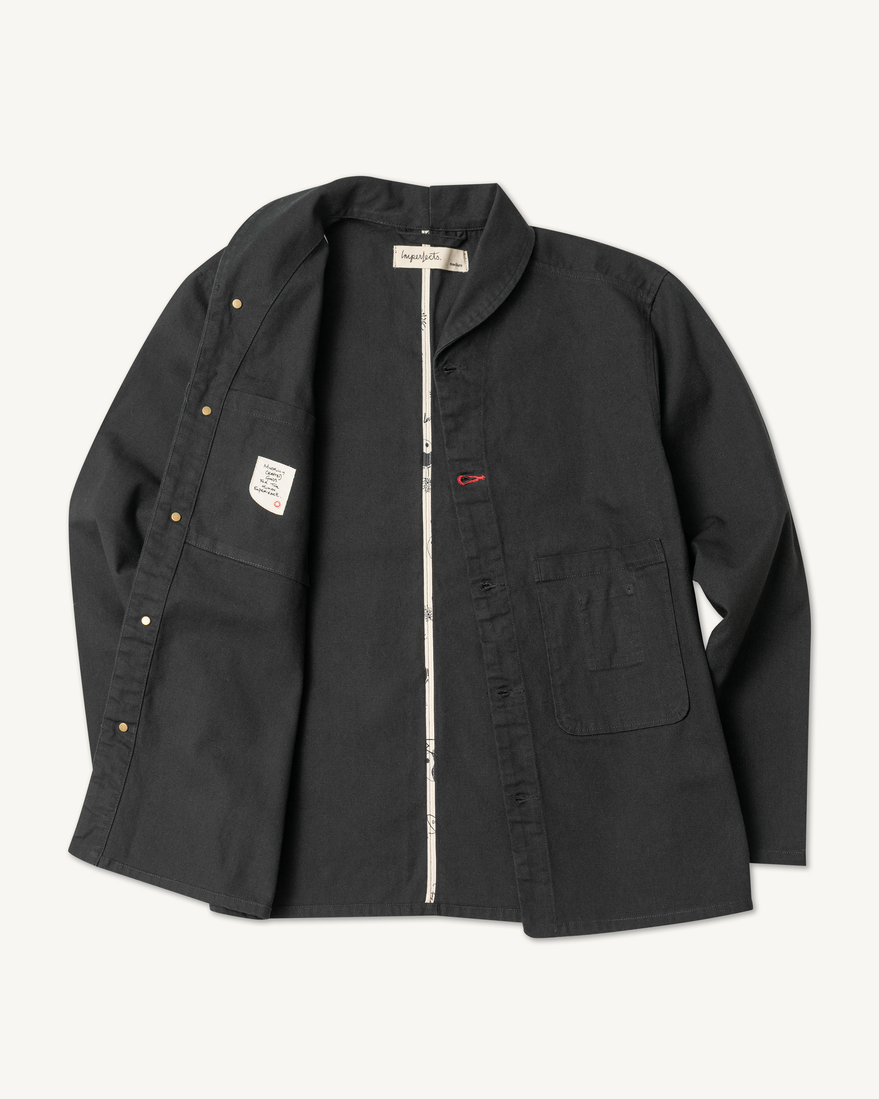 The Shepherds Shirt is a silhouette born of the joining of a family favorite vintage Kimono and a 1920’s French field shirt. This piece has a Kimono style lip collar, French split side seams, and Corozo Buttons. It is finished with a heavy stone wash for effect and comfort and has a refined crop in the sleeves so you can be sure to easily check your timepiece. Obsidian. 