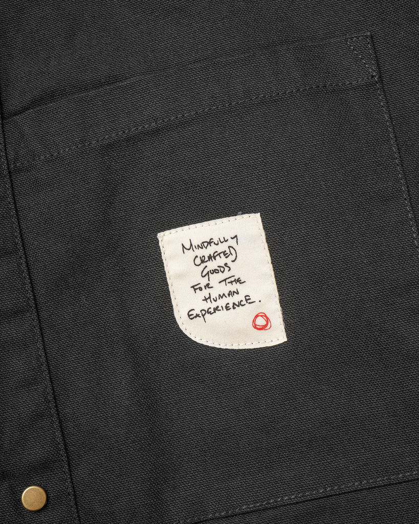 The Shepherds Shirt is a silhouette born of the joining of a family favorite vintage Kimono and a 1920’s French field shirt. This piece has a Kimono style lip collar, French split side seams, and Corozo Buttons. It is finished with a heavy stone wash for effect and comfort and has a refined crop in the sleeves so you can be sure to easily check your timepiece.

Detail

9.2oz, 100% Organic Cotton Canvas
Durable Brass Tack Buttons
Triple Pocketing - One &nbsp;Internal Drop-In Pocket, One External w/ Hidden Co